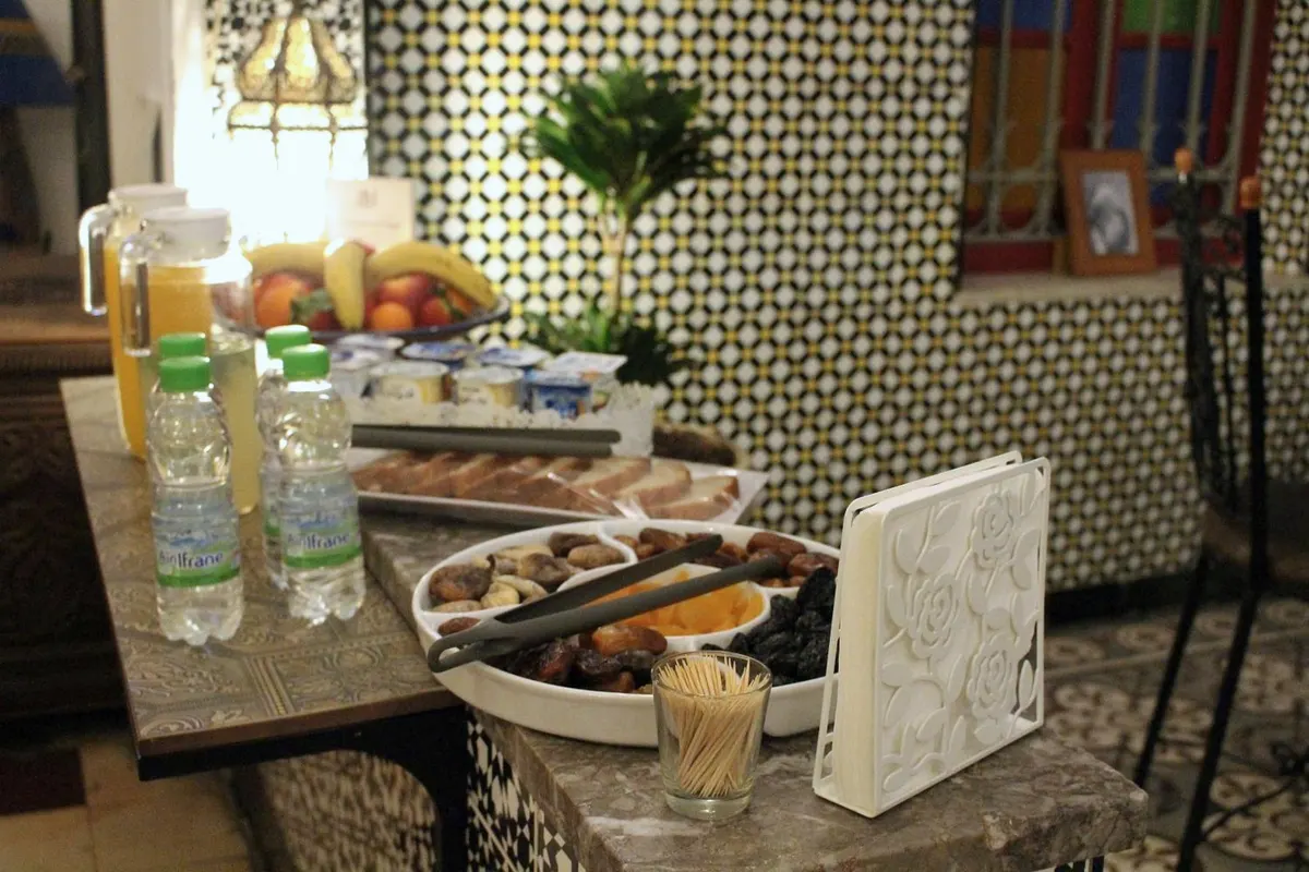 Fruit, juices and bread on the zellige counter