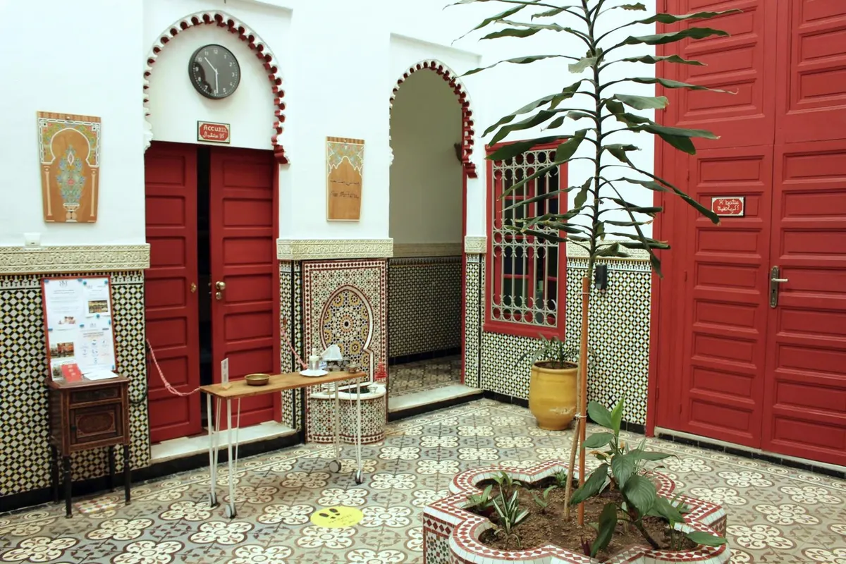 The riad’s reception, off the patio: red doors, arches and zellige