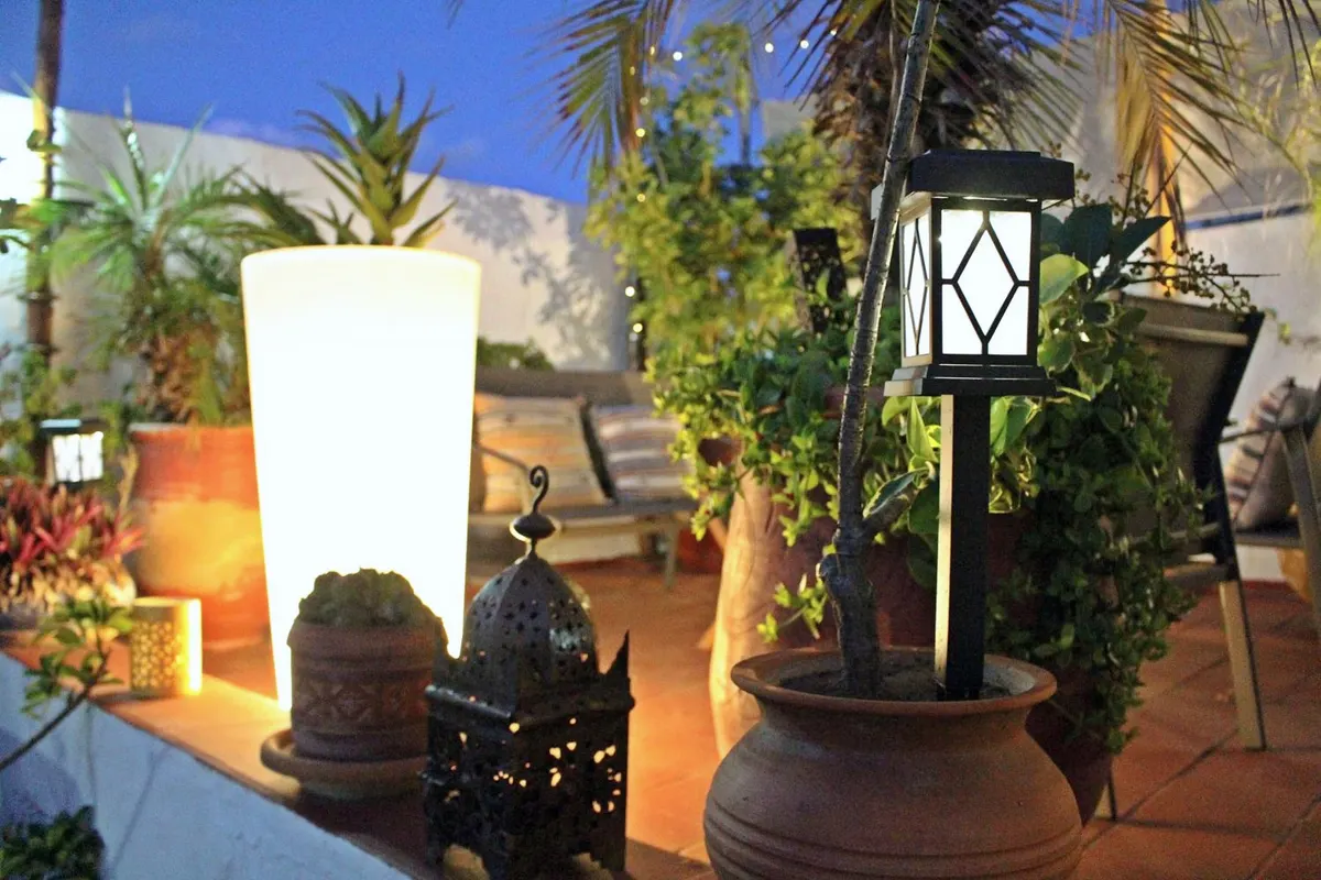 The terrace at dusk, lamp and lantern lit