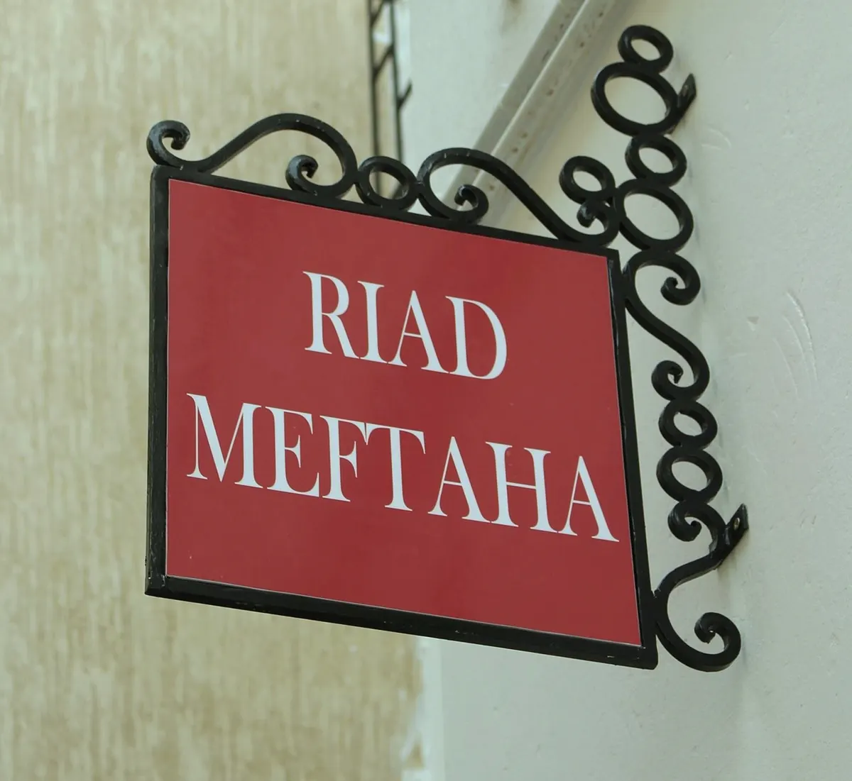 The red “Riad Meftaha” sign on its wrought-iron bracket