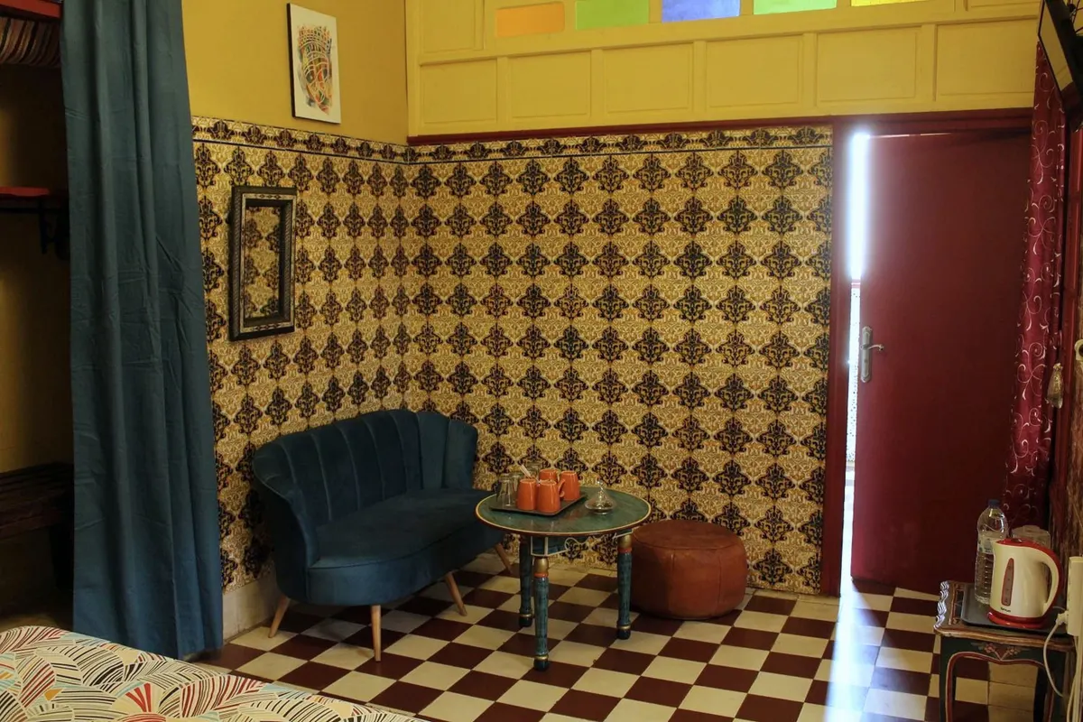Teal velvet armchair, zellige and checkerboard floor