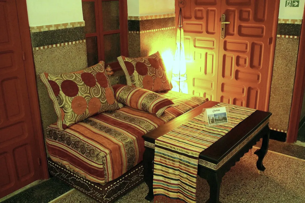 The private salon of Chellah: striped sofa and carved red door