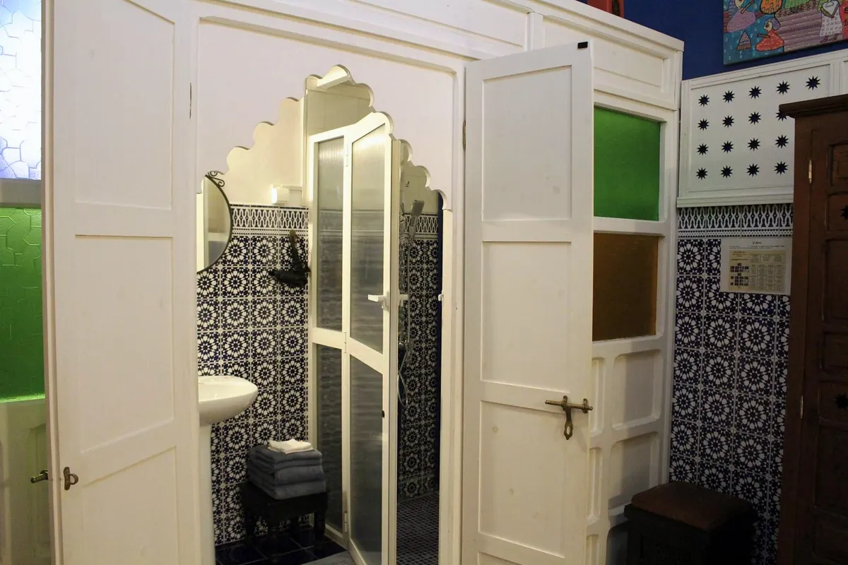 R’Batia shower room behind carved white doors